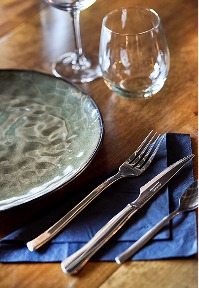 Table setting with plate, cutlery, and glasses for private dining